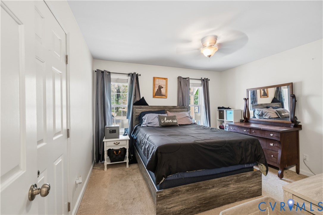 20108 Eugene Drive Sutherland, VA 23885 - Photo 21 of 41 a bedroom with a bed and a chandelier