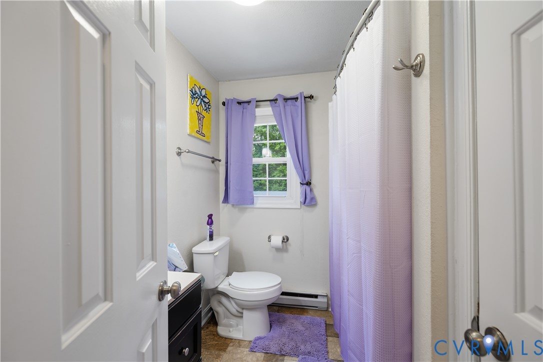 20108 Eugene Drive Sutherland, VA 23885 - Photo 24 of 41 a bathroom with a granite countertop toilet a sink and a mirror