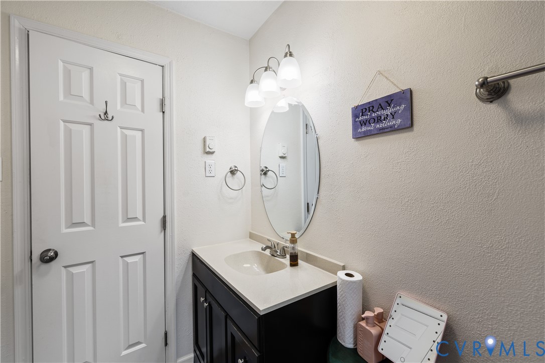 20108 Eugene Drive Sutherland, VA 23885 - Photo 25 of 41 a bathroom with a sink vanity and a mirror