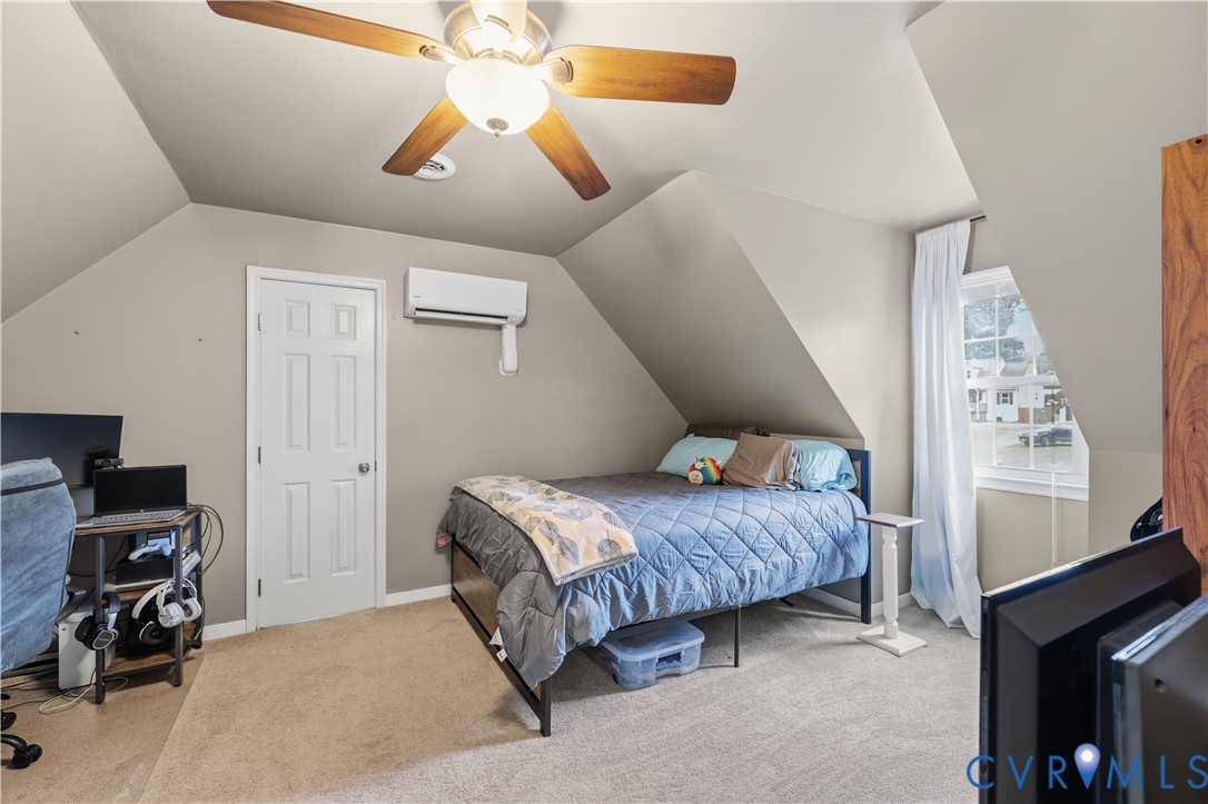 20108 Eugene Drive Sutherland, VA 23885 - Photo 26 of 41 a bedroom with a bed and a chandelier