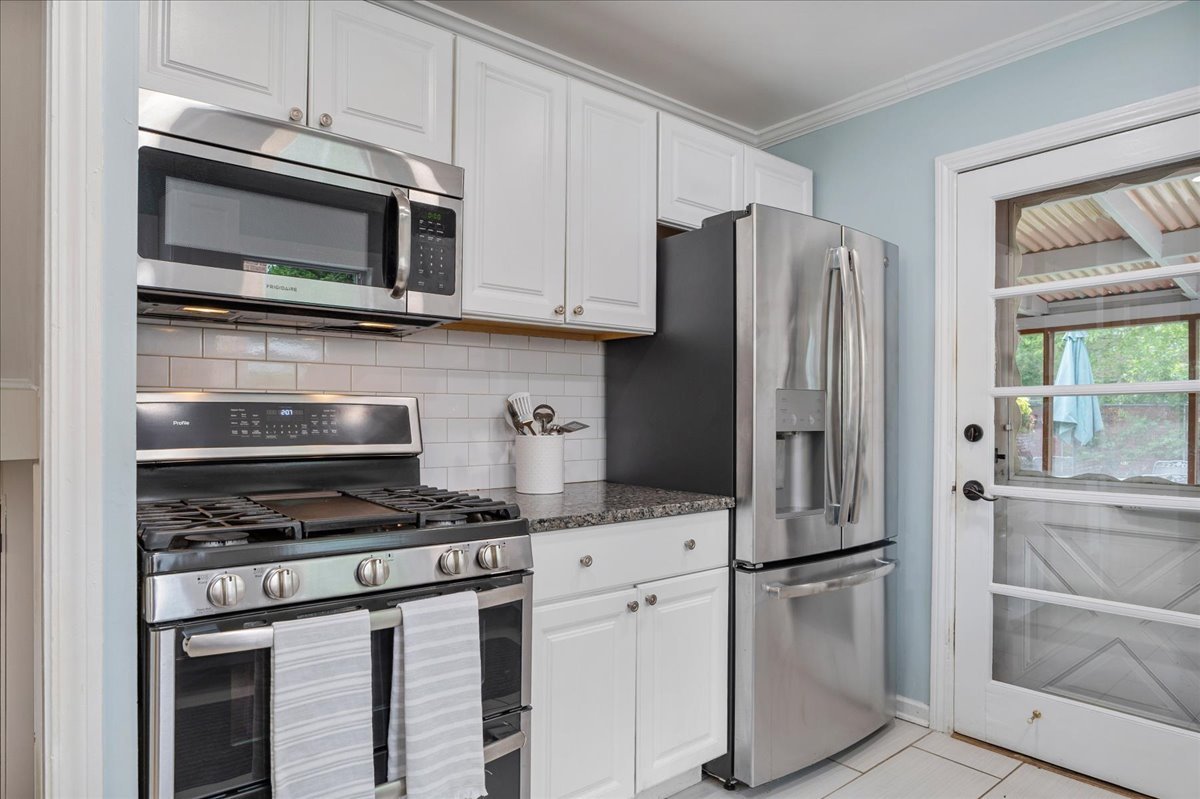 630 Long Road Glenview, IL 60025 - Photo 8 of 24 a kitchen with stainless steel appliances white cabinets and a stove a refrigerator with wooden floor