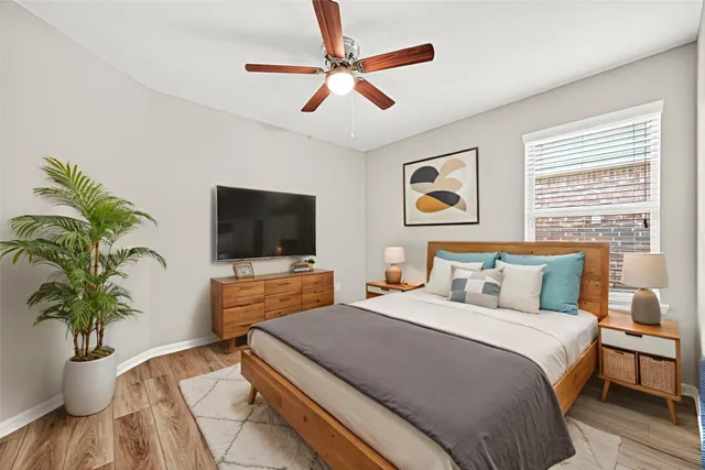 a bedroom with a large bed and a flat screen tv