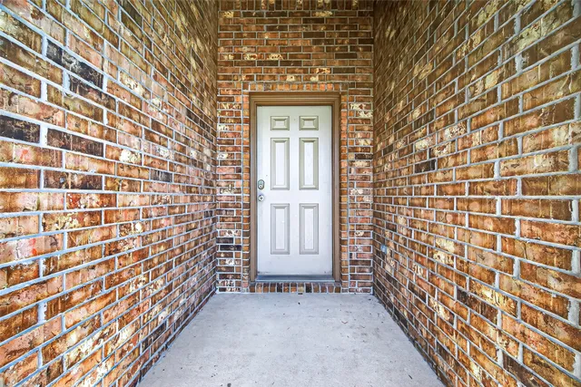 a view of a brick house with many windows