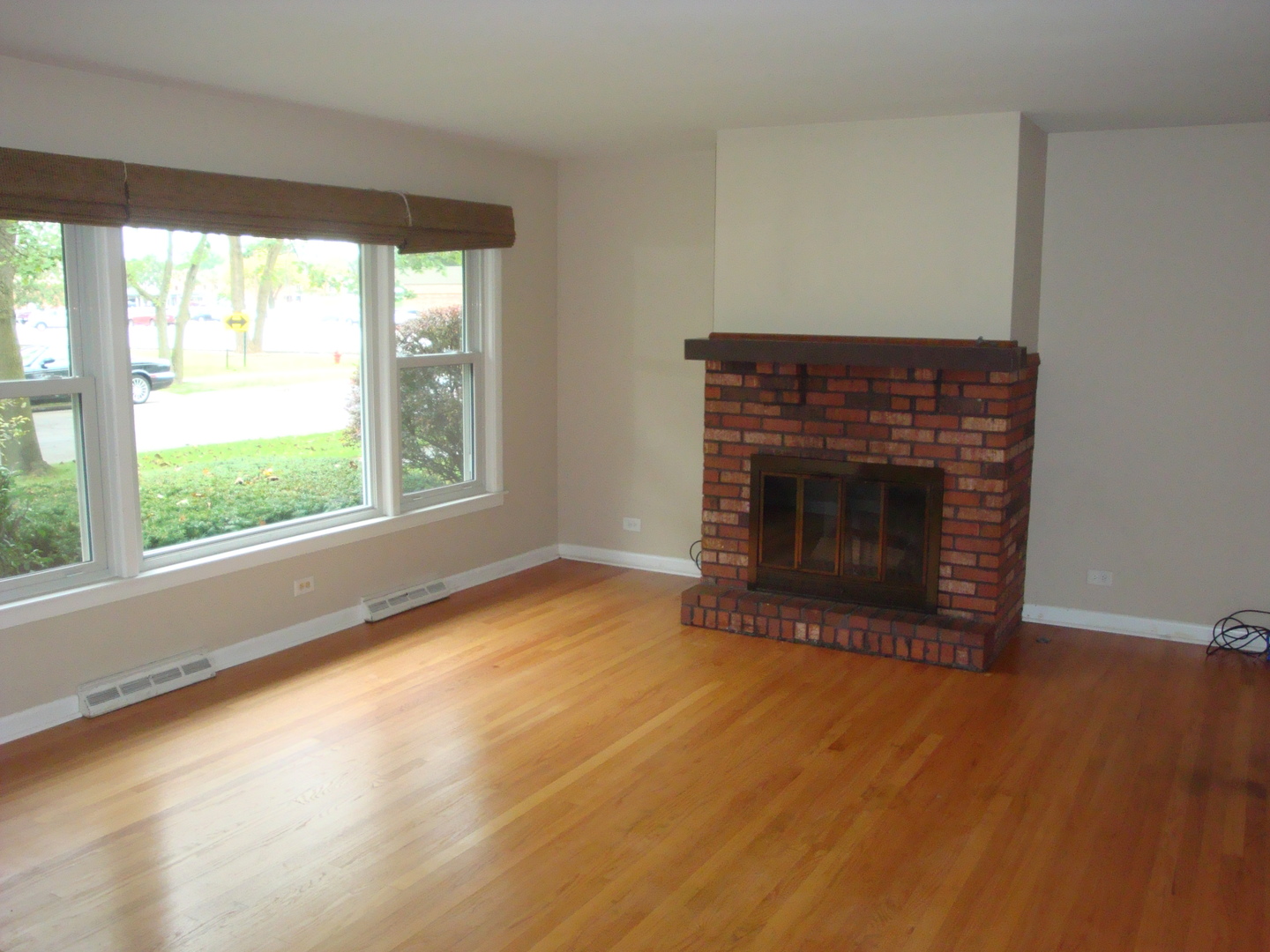 601 Forest Road La Grange Park, IL 60526 - Photo 6 of 22 a view of empty room with wooden floor and fireplace