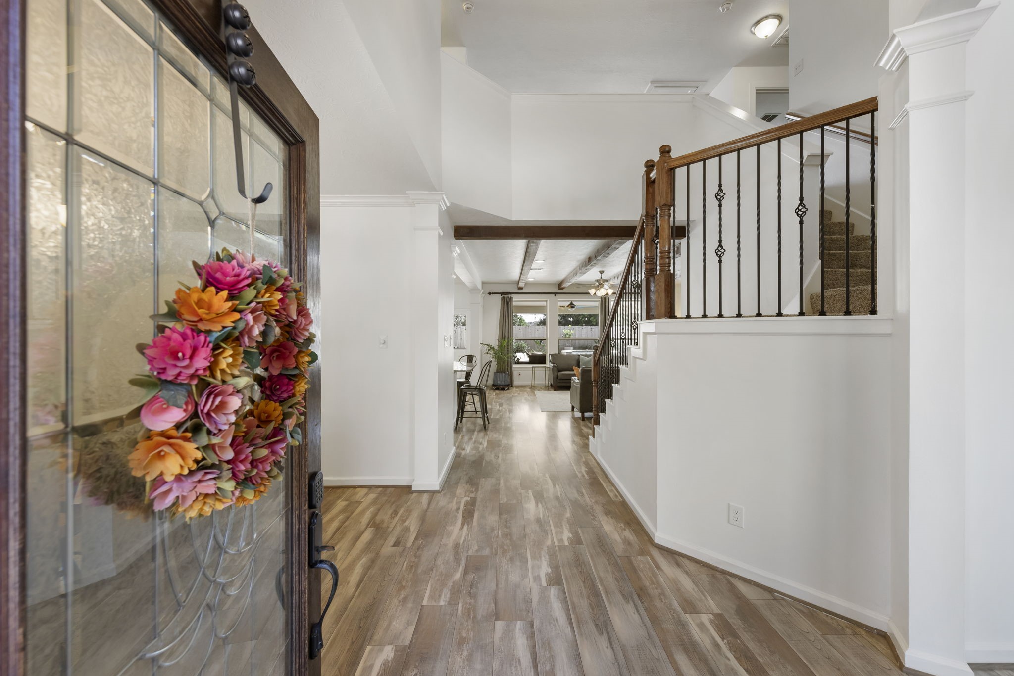 3318 Solvista High Court Spring, TX 77386 - Photo 2 of 33 Step inside to a bright, welcoming entry featuring soaring ceilings, engineered hardwoods in main living areas, elegant staircase with wrought-iron balusters, and a seamless flow into the home's open-concept living spaces.