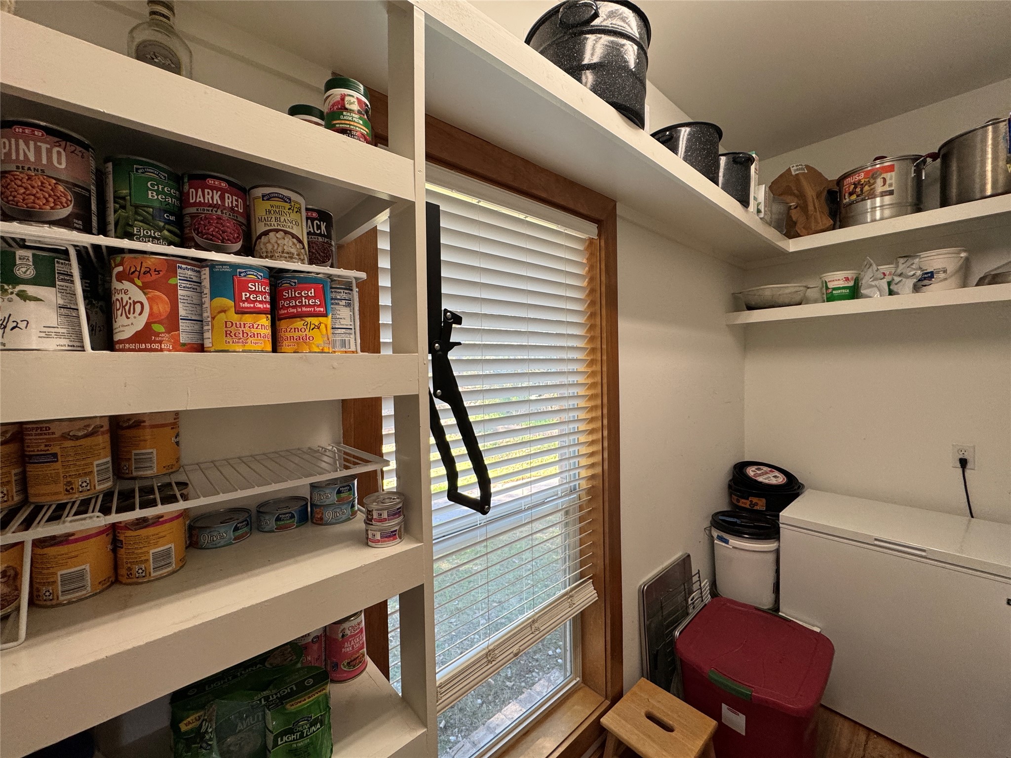 55 Lake Road Huntsville, TX 77320 - Photo 29 of 50 The pantry also hasa window with blinds, natural light, and room for a chest freezer, providing great storage and functionality.