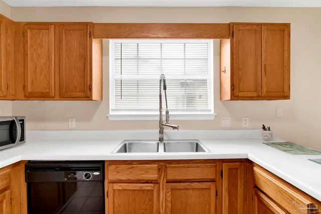 a kitchen with stainless steel appliances granite countertop a sink and a cabinets