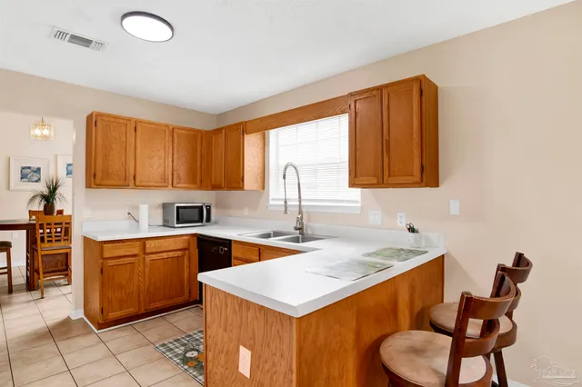 a kitchen that has a sink and a stove in it