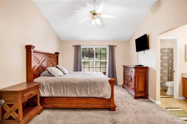 a bed sitting in a bedroom next to a window