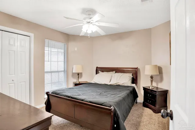 a bedroom with a large bed and a large window