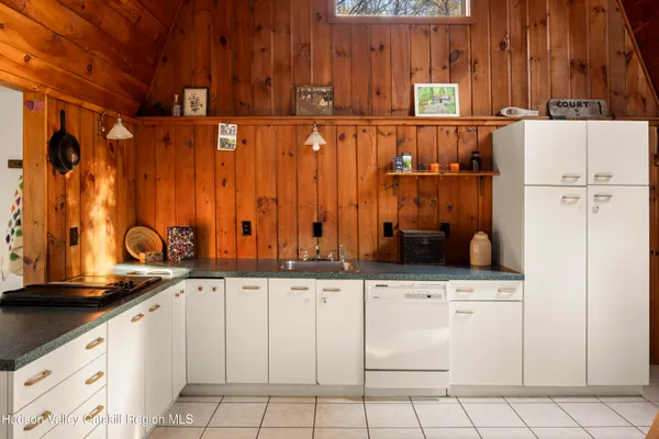 a view of a kitchen with furniture and a refrigerator