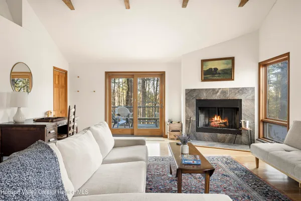 a living room with furniture a rug and a large window