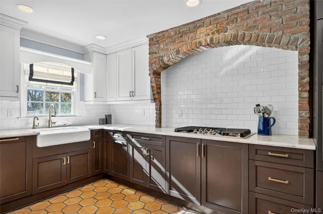 a kitchen with a sink stove and cabinets