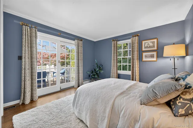 a bedroom with a large bed and a lamp next to a window