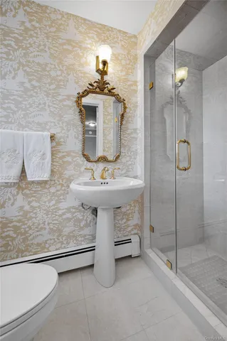 a bathroom with a sink a mirror and shower