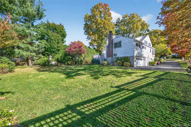 a house is sitting in middle od the grass