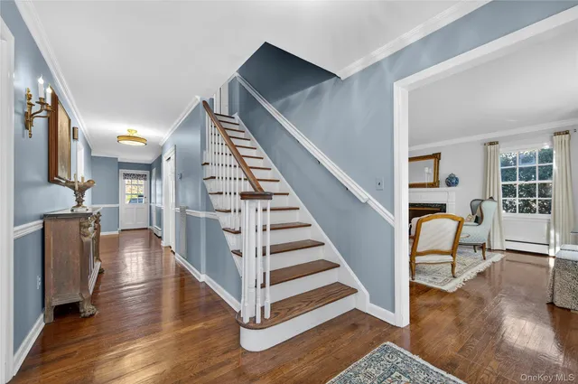 a view of entryway and hall with wooden floor