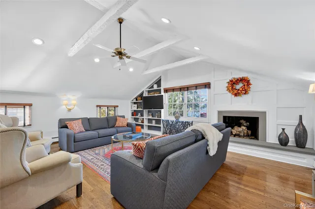 a living room with furniture a fireplace and a chandelier