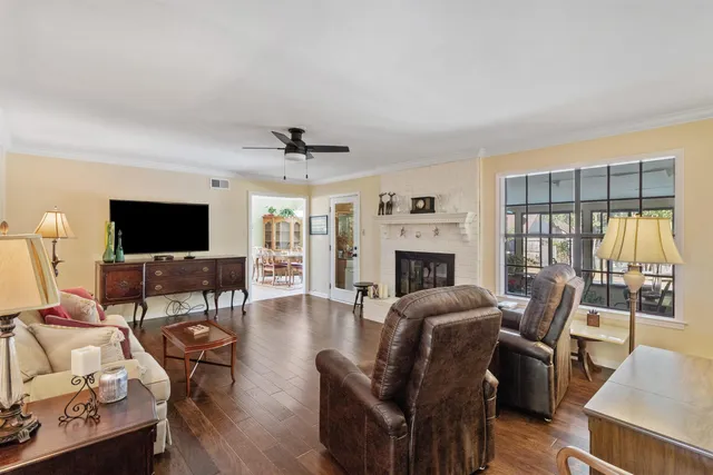 a living room with furniture a flat screen tv and a fireplace