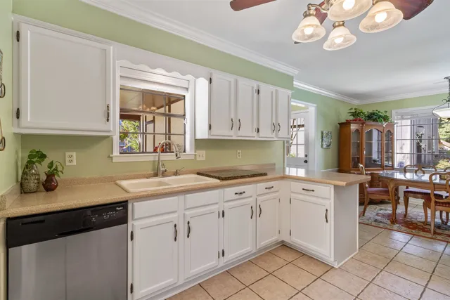 a kitchen with a sink window and cabinets