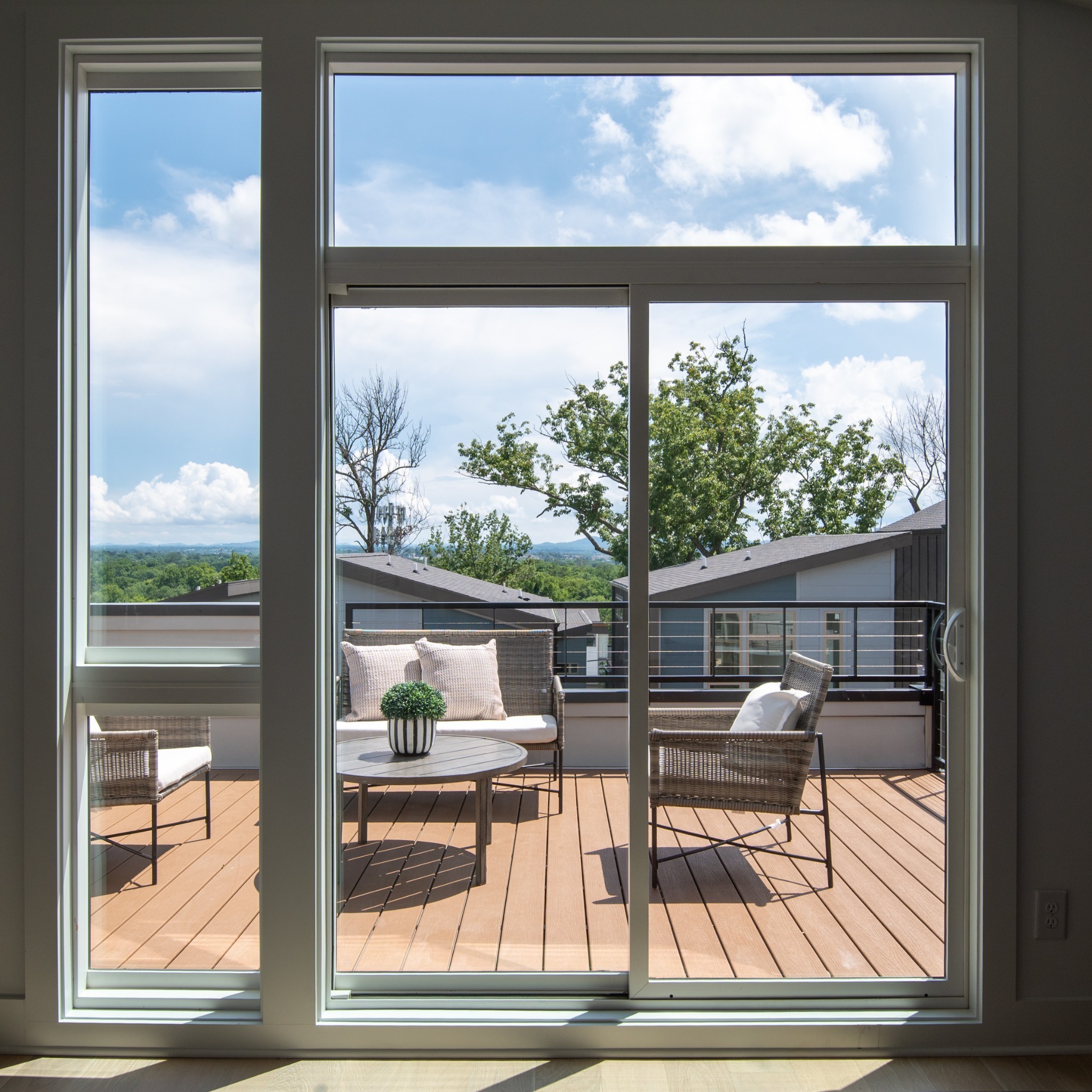 a view of living room with a floor to ceiling window and wooden floor