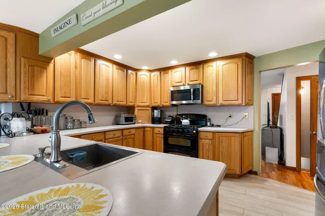 a kitchen with stainless steel appliances granite countertop a refrigerator and a sink