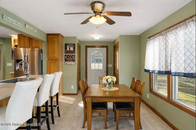 a bedroom with a bed a dresser next to a window