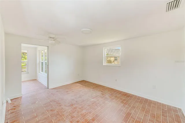 an empty room with windows and closet
