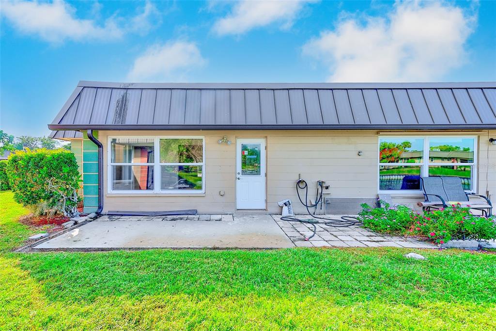 4308 Summersun Drive New Port Richey, FL 34652 - Photo 25 of 42 a view of a patio with table and chairs potted plants and wooden fence