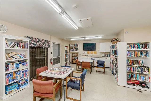 a living room with furniture and a book shelf