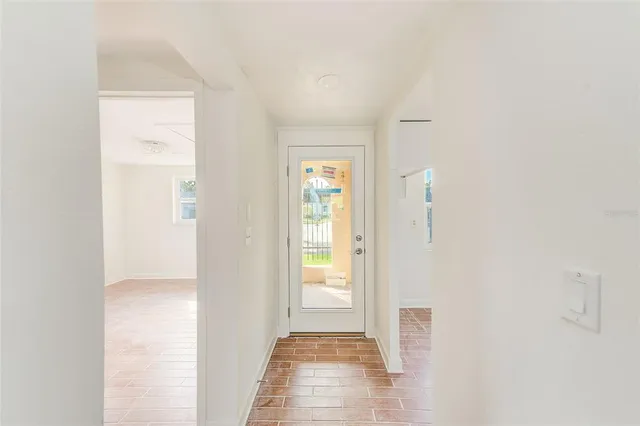 a view of a hallway with wooden floor and closet