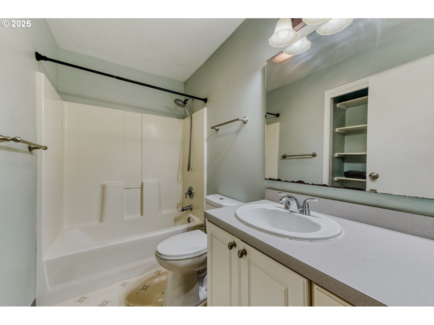 8426 Northeast Wygant Street Portland, OR 97220 - Photo 11 of 17 a bathroom with a sink toilet a mirror and shower