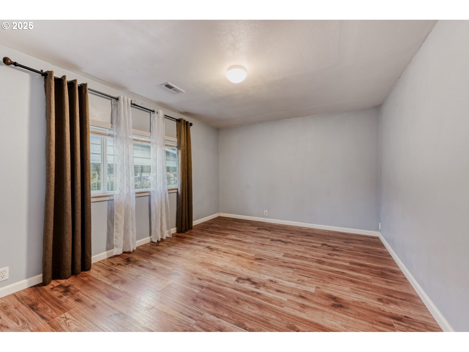 8426 Northeast Wygant Street Portland, OR 97220 - Photo 14 of 17 a view of an empty room with wooden floor and a window