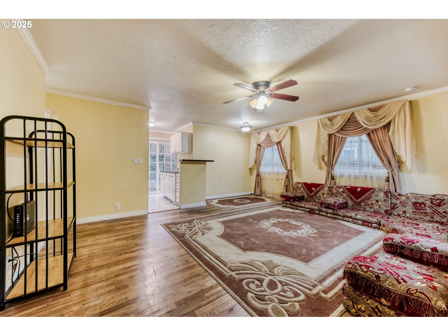8426 Northeast Wygant Street Portland, OR 97220 - Photo 4 of 17 a view of a livingroom with furniture and a ceiling fan