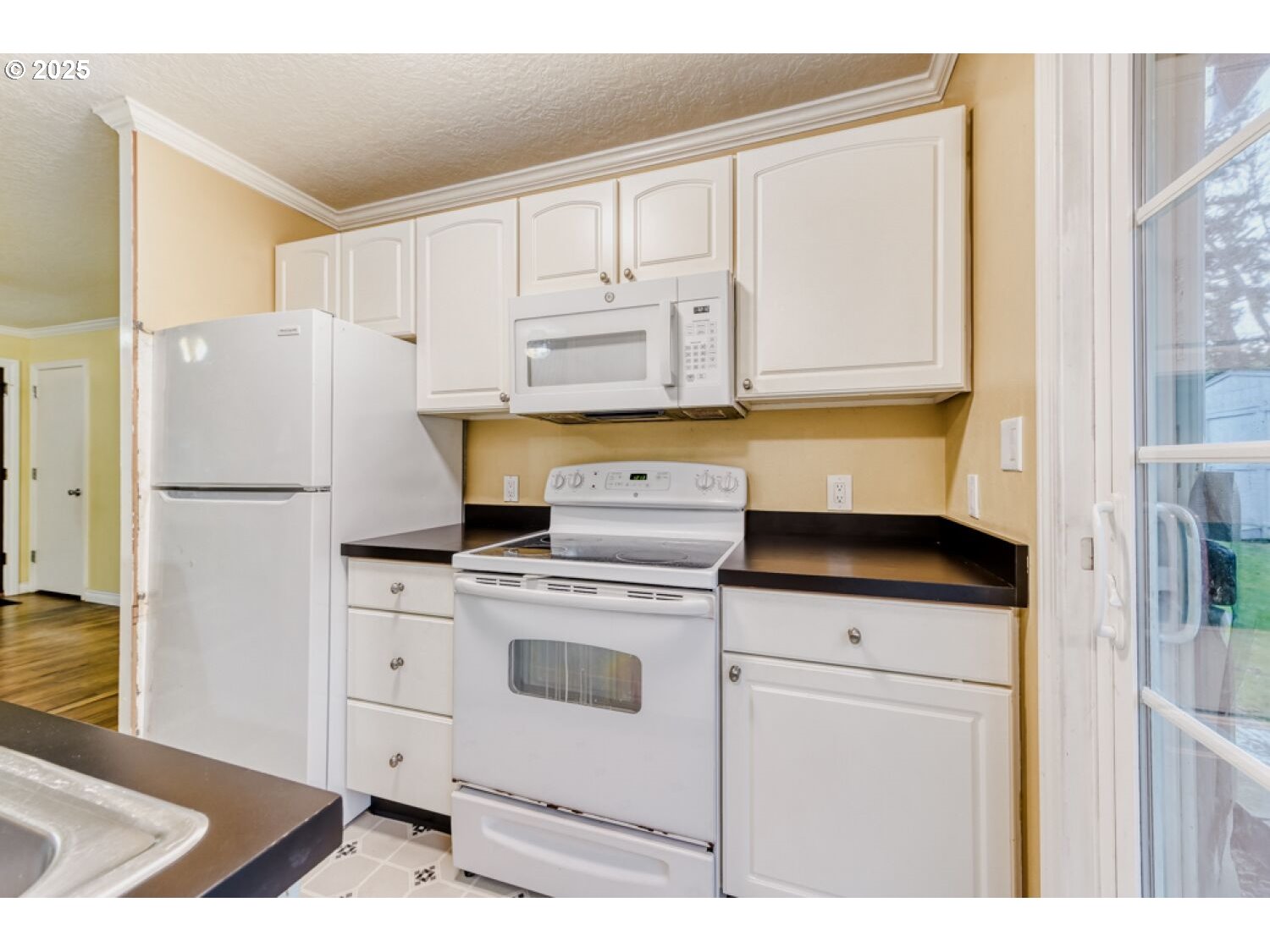 8426 Northeast Wygant Street Portland, OR 97220 - Photo 6 of 17 a kitchen with a stove a refrigerator and a sink