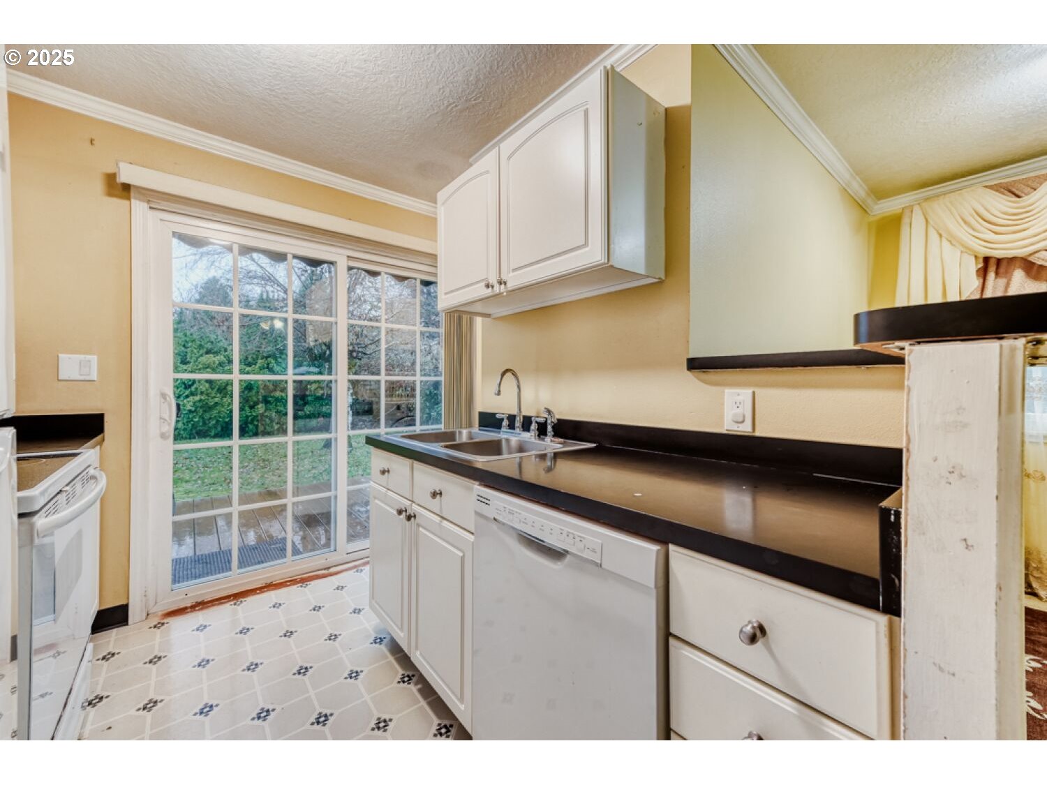 8426 Northeast Wygant Street Portland, OR 97220 - Photo 7 of 17 a kitchen with granite countertop a sink stove and cabinets