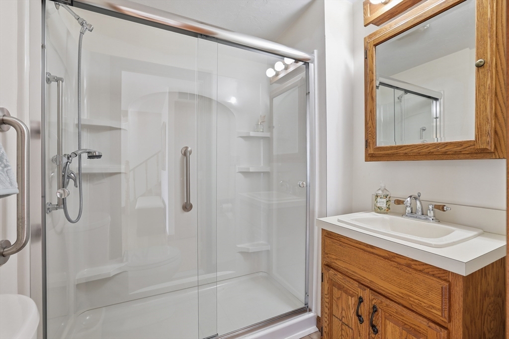 7 Swift Avenue Wareham, MA 02571 - Photo 11 of 42 a bathroom with a shower sink vanity and mirror