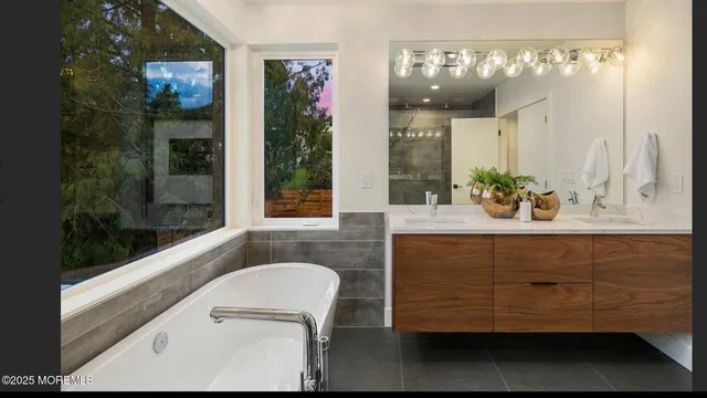 a bathroom with a sink a vanity and a large mirror