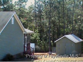 82 Ridgecrest Road Cameron, NC 28326 - Photo 2 of 12 a backyard of a house with table and chairs
