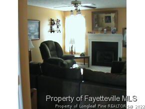 82 Ridgecrest Road Cameron, NC 28326 - Photo 6 of 12 a living room with furniture and a fireplace