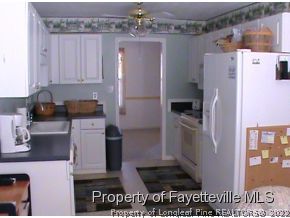 82 Ridgecrest Road Cameron, NC 28326 - Photo 7 of 12 a kitchen with a refrigerator and cabinets