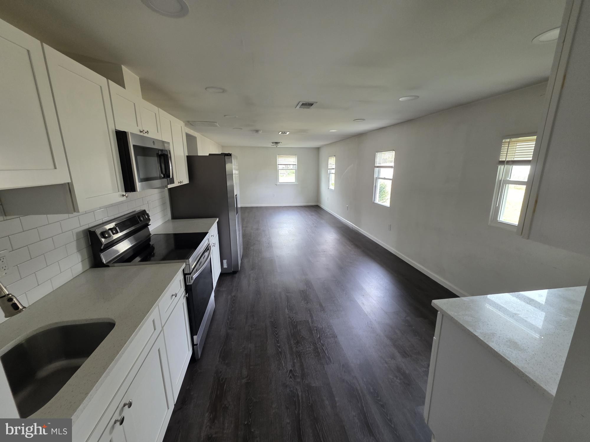203 East Cedarville Road Pottstown, PA 19465 - Photo 11 of 17 a kitchen with a sink a microwave and cabinets