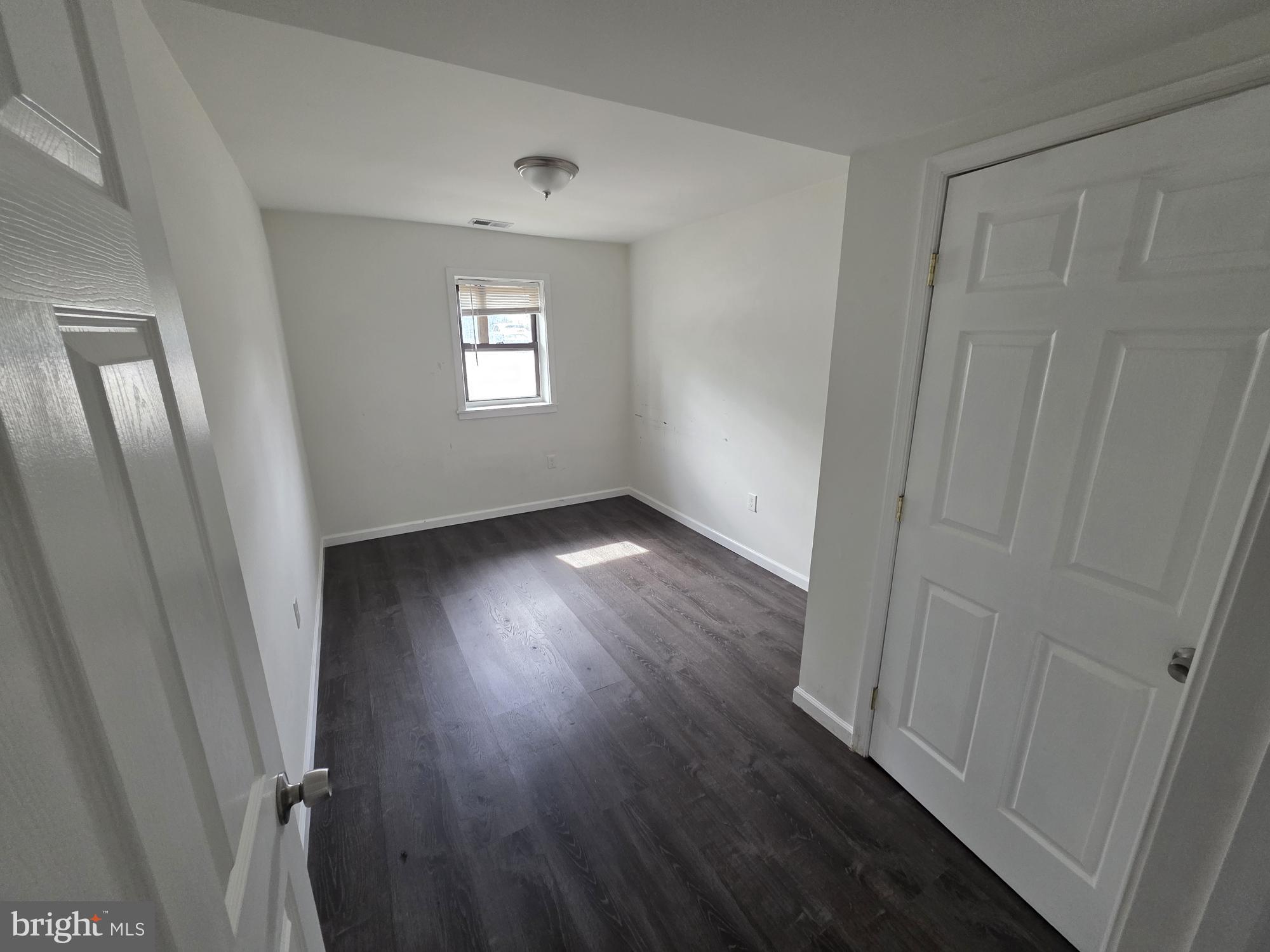 203 East Cedarville Road Pottstown, PA 19465 - Photo 6 of 17 a view of an empty room with wooden floor and a window