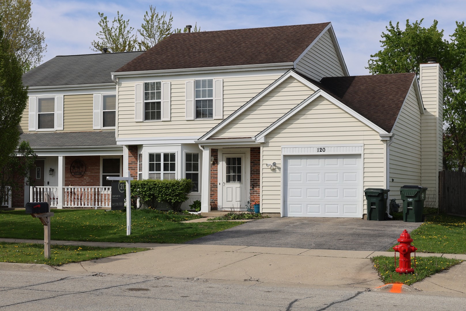 120 North Southport Road Mundelein, IL 60060 - Photo 1 of 10 a view of a white house with a small yard plants and a large tree