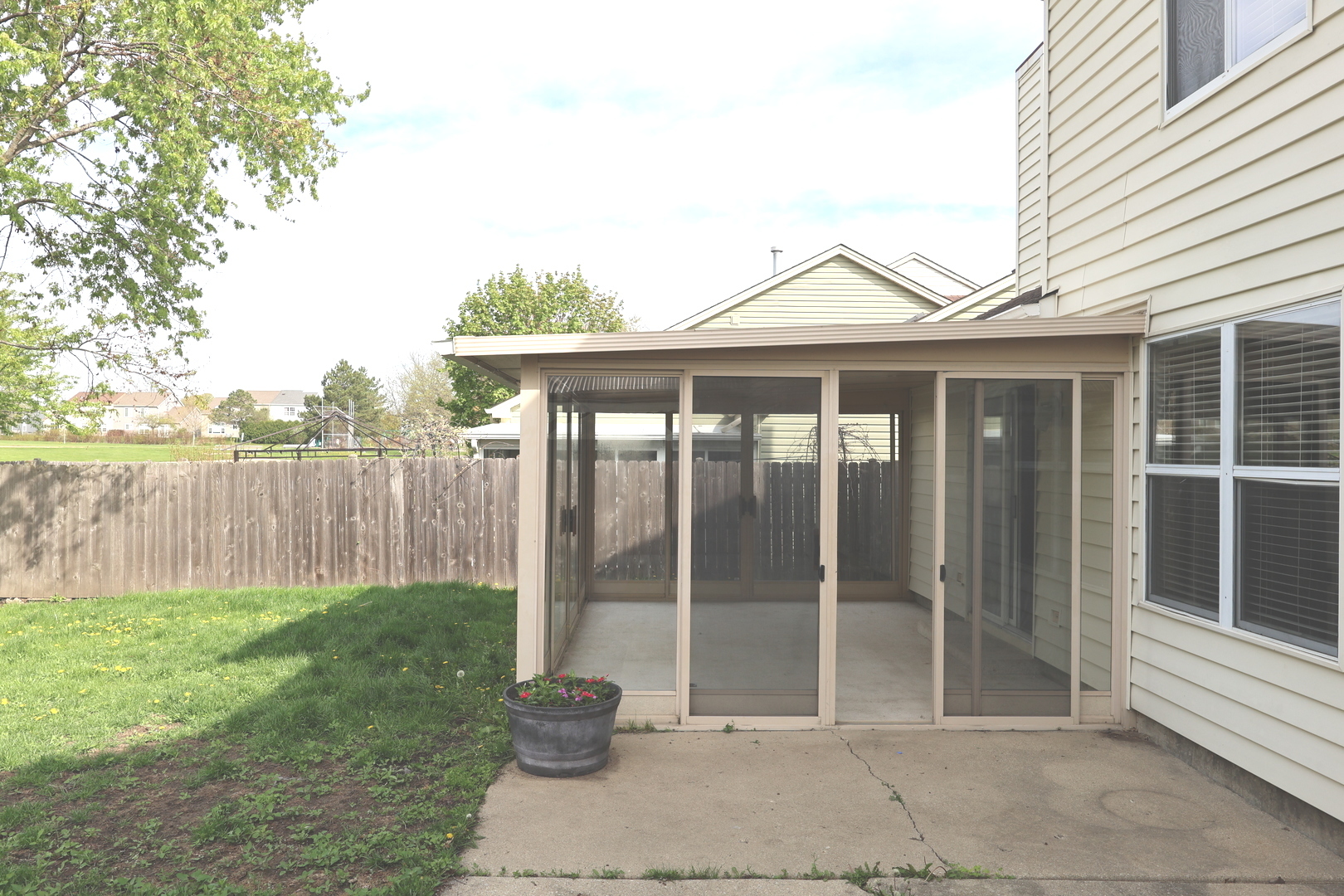 120 North Southport Road Mundelein, IL 60060 - Photo 2 of 10 a backyard of a house with lawn chairs and iron fence