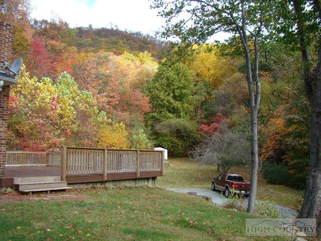 135 Ivy Ridge Road Deep Gap, NC 28618 - Photo 3 of 16 a backyard of a house with table and chairs
