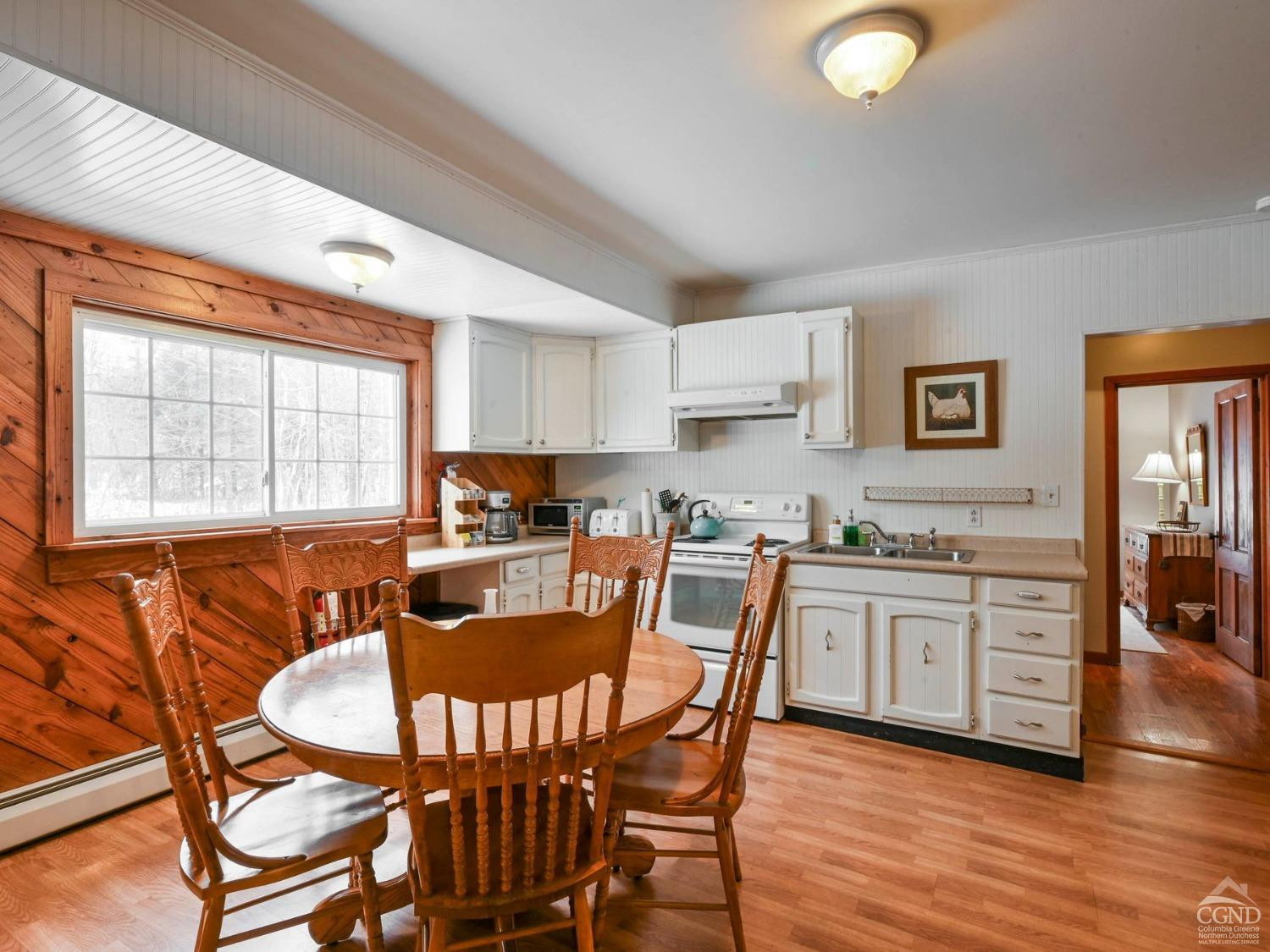 110 Maplecrest Road Windham, NY 12439 - Photo 13 of 73 a kitchen with granite countertop a stove a sink a dining table and chairs