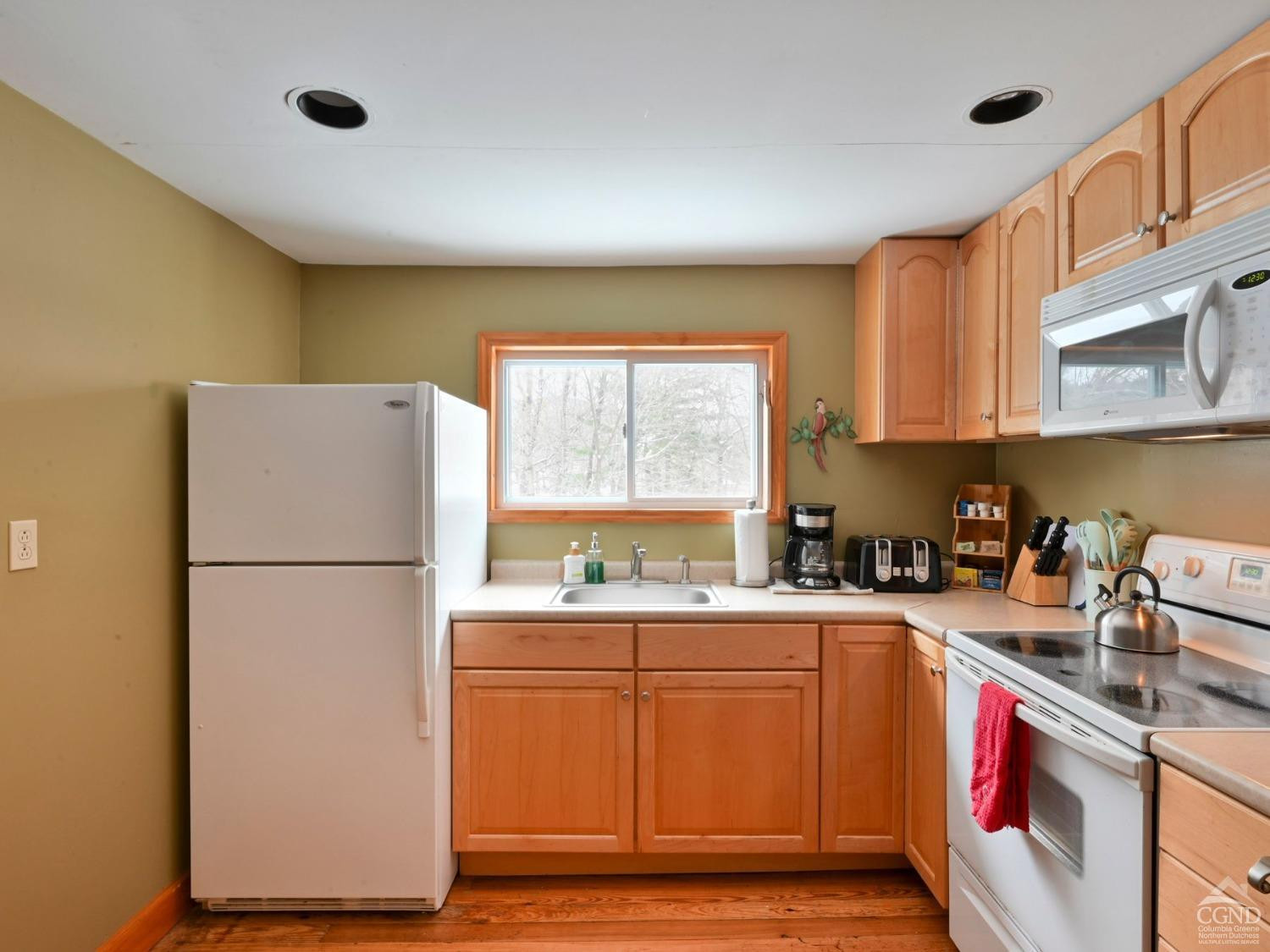 110 Maplecrest Road Windham, NY 12439 - Photo 52 of 73 a kitchen with a sink a refrigerator and a stove top oven