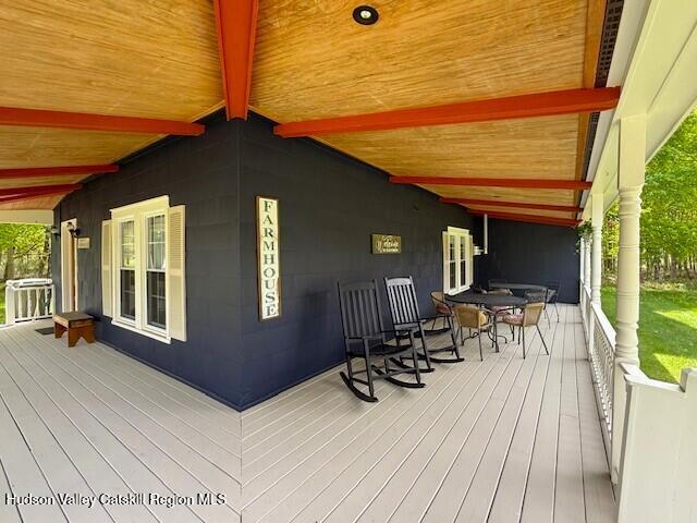 110 Maplecrest Road Windham, NY 12439 - Photo 7 of 73 a view of balcony with chairs and wooden floor