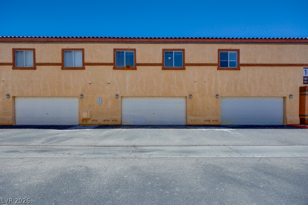 4915 East Russell Road, Unit 127 Las Vegas, NV 89120 - Photo 18 of 19 Attached garage doors provide convenient parking for this multi-family residence.